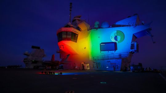 Flagship HMS Queen Elizabeth showed Pride colours on global deployment to coincide with World Pride 21082021 CREDIT Royal Navy Royal Navy Compass Twitter.jpeg