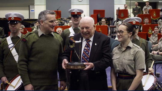 Former RM musician presents his drum to today's Band Service CREDIT ROYAL NAVY