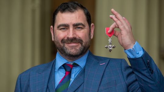 Cover image: Andy Reid received an MBE in November 2019 (Picture: PA).