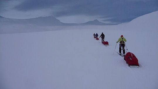 Four anonymous explorers trekking across the Antarctic