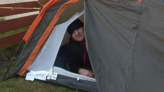 Gavin Dickinson Army Scripture Reader poses in his tent after a night sleeping outdoors for charity 250321 CREDIT BFBS