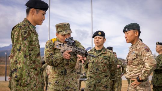 A Gurkha from the 1st Battalion, The Royal Gurkha Rifles shows Japanese soldiers the British SA80 A3 rifle during Exercise Vigilant Isles in Japan (Picture: British Army)