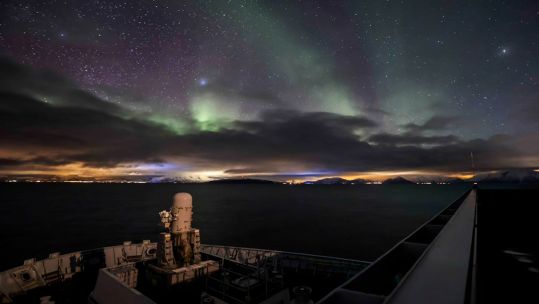 HMS Albion with the northern lights in the background as it prepares for Exercise Cold Response (Picture: HMS Albion/Twitter).