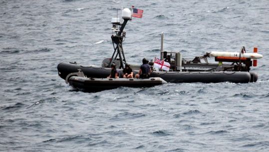 HMS Bangor's sea boat meets up with the US robot boat (Picture: Royal Navy).