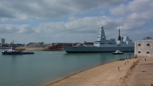 HMS Daring being towed from Portsmouth Naval Base for engine refit 150921 CREDIT PA ALAMY.jpg