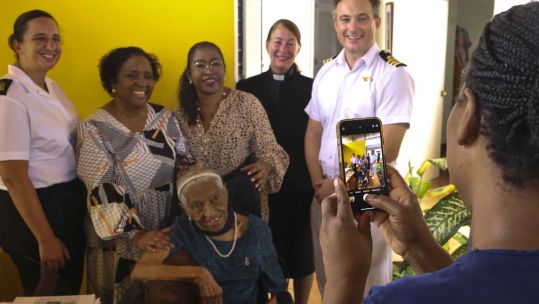 HMS Dauntless' ship's company meets Second World War veteran Ena Collymore-Woodstock and her family in Barbados CREDIT Royal Navy