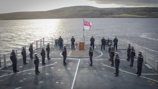 HMS Forth company holds commemorative service for Falklands heroes near HMS Antelope wreckage (Picture: Royal Navy).