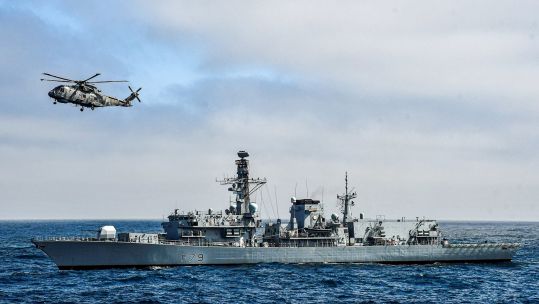 HMS Portland's Merlin flies over the ship's forecastle during Ex Dynamic Mongoose 22 DATE UNKNOWN CREDIT NATO