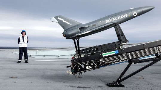 HMS Prince of Wales crew with Fixed-wing drone (Picture: Royal Navy).