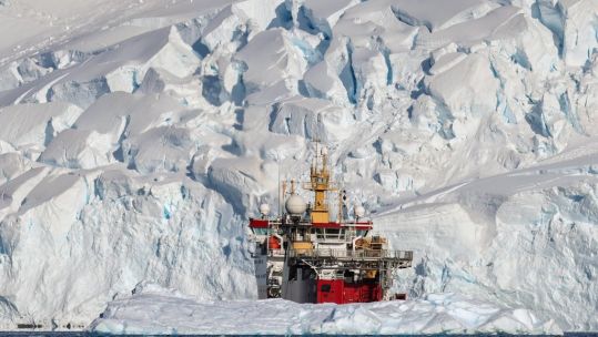 HMS Protector's red hull shows up against the ice and snow (Picture: Royal Navy Twitter).