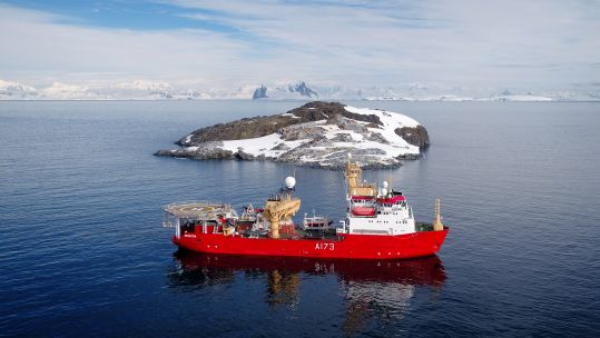HMS Protector sails close to Fizkin Island, part of the Pitt Islands, in the Antarctic