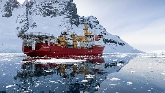 HMS Protector sails through the Lemaire Channel, Antarctica