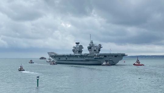 HMS Queen Elizabeth passes the Nab Tower as she heads into the Solent