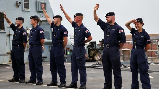 HMS Duncan's crew waving goodbye to their families at Portsmouth Naval Base (Picture: Royal Navy).
