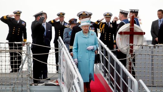 Queen Elizabeth II is saluted by the Officers of HMS Lancaster during a visit to HMS Lancaster at Portsmouth Naval Base (Picture: Alamy).