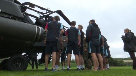 Harlequins players being shown around the Apache.