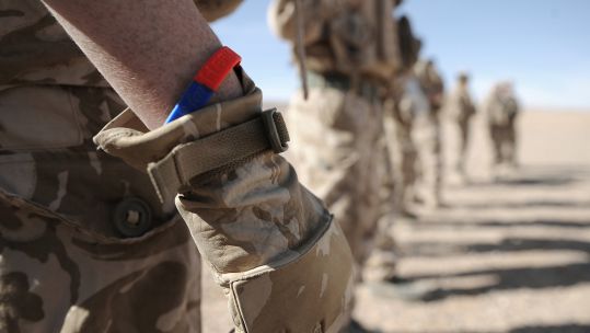Help For Heroes wristband on anonymous soldier