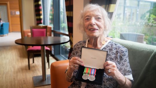 Holocaust survivor Henny Franks holds her war medals as she celebrates her 100th birthday at the Jewish Care Holocaust Survivors' Centre, north west London