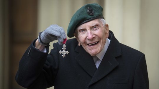 Horace 'Harry' Billinge holding his MBE at Buckingham Palace