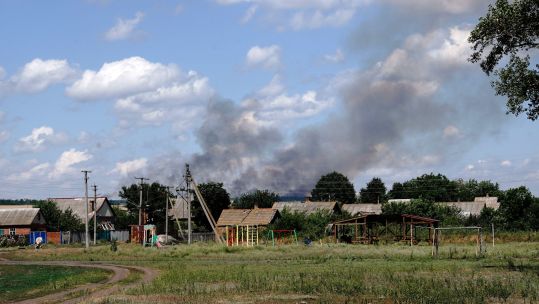 moke caused by the shelling of Russian troops rises from behind the houses, Donetsk Region, eastern Ukraine (Picture: Ukrinform, Alamy Stock Photo).