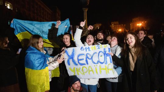  People hold a banner that says ''Kherson is Ukraine'' celebrating the liberation of Kherson from Russian occupiers in central Kyiv.