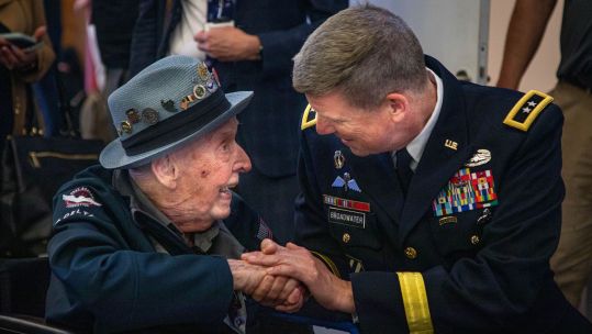 Major General Jeff Broadwater, the deputy commanding general of V Corps, talks to Jake Larson during the D-Day 79 commemorations in France