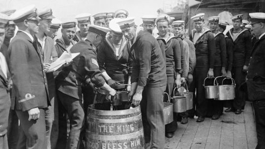 Image ID 2BJ03CC Sailors aboard HMS Hood stand in line to draw a rum ration in preparation of drinking to the King's health on 15 July 1935 CREDIT Picture Kitchen Alamy Stock Photo EXP 04112023
