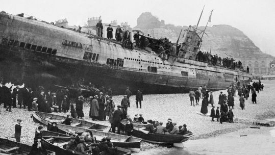 Image ID KF053K People in rowing boats and on the beach, looking up at the German U-boat submarine, U-118, which ran aground on Hastings beach on 15 April 1919 CREDIT Arcaid Images Alamy Stock Photo EXP 231124