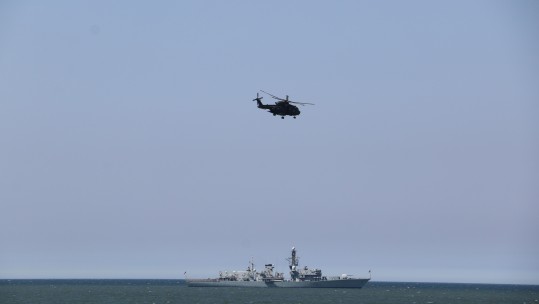HMS Somerset and Merlin Helicopter in Llandudno Bay