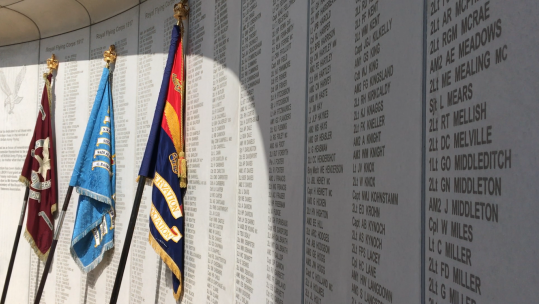 Army Air Corps flags against memorial