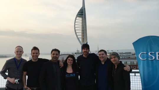 The Forces Live Events (CSE) and Forces Radio BFBS teams pose for a pre-show photo with an amazing view in Portsmouth