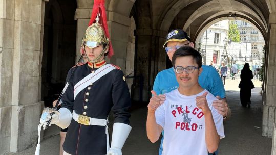Ibrahim and Mike van Erp stood next to a Trooper of the Blues and Royals CREDIT CyclingMikey