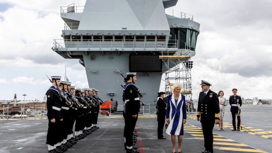 The Duchess of Cornwall is greeted by a guard of honour as she arrives for a visit to HMS Prince of Wales (PA Images/ Alamy stock photo).