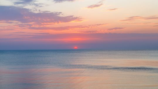 Sunset and blue sea with waves at the Baltic Sea (Picture: Tartezy/Alamy Stock Photo).