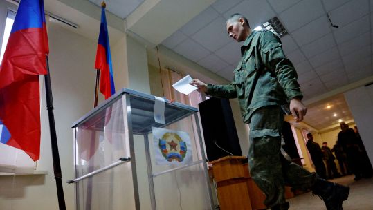 A service member of the self-proclaimed Luhansk People's Republic LPR votes during a referendum on joining LPR to Russia (Picture: REUTERS/Alexander Ermochenko).