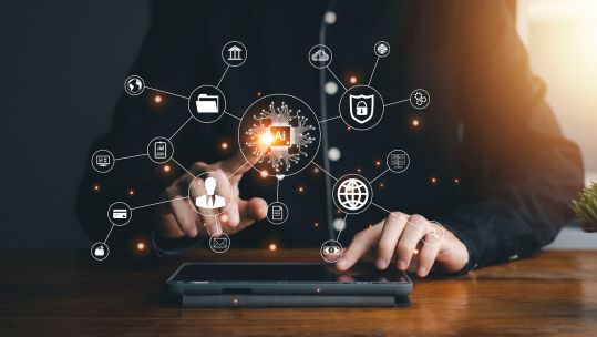 Businessman hand touch tablet with hologram technology (Picture: Sinlapachair Jaijumpa/Alamy Stock Photo).