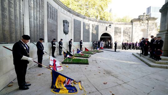 Image ID 2KEAF34 Flag bearers, veterans and members of the public observe a two minute silence an Armistice Day at WW1 memorial Guildhall Square Portsmouth 111122 EXP 041123 CREDIT PA IMAGES, ALAMY