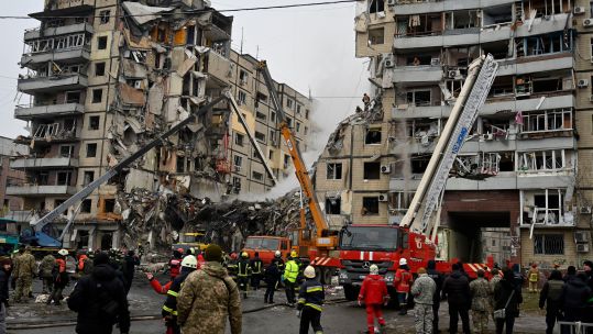 Rescuers dismantle the rubble of a destroyed house as a result of a missile attack by Russian
