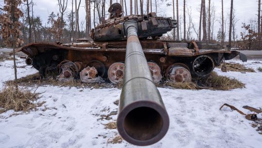 A destroyed Russian Tank lays beside the road in Bucha (Picture: Alamy).