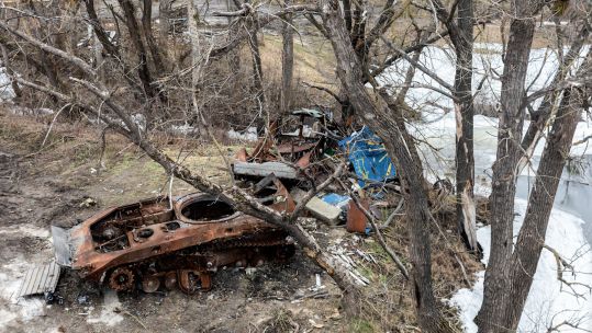 Image ID 2P26GBH burnt tank and destroyed trees in Bogorodychne, Ukraine, Donetsk Oblast village 03032023 CREDIT Zuma Alamy EXP 28032024