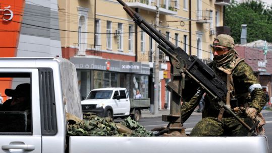 Fighters of the Wagner group pictured outside the Russian Southern Military District staff HQ (Picture: Alamy).