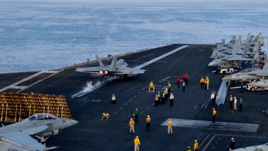 Aircraft carrier USS Dwight D Eisenhower flight deck operation in Gulf of Oman (Picture: Nicholas Rodriguez, Alireza Boeini, Alamy Stock Photo).