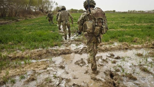 Image ID G521EF ANON Soldiers trudge through flooded field while on patrol in the Deh Adam Khan, Afghanistan 23032012 CREDIT PA Images,Alamy Stock Photo.jpg