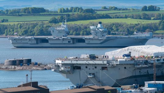 Aircraft carrier HMS Queen Elizabeth moored off Rosyth in River Forth after leaving dry dock in 2019 (Picture: Alamy Stock Photo).