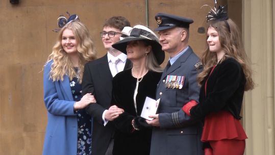 Investiture at Buckingham Palace Wing Commander Sebastian Kendall with his family 191219 CREDIT BFBS