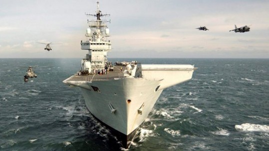 HMS Invincible flanked by Sea Kings and Sea Harriers 