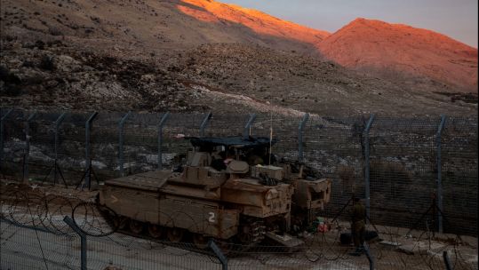 Israeli troops are seen near the buffer zone fence on the eastern side of the Golan Heights, on 101224 CREDIT Alamy