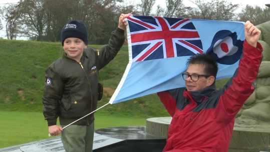 Jacob Newson and his father, Andy Newson, holding up an RAF flag after completing their 30 mile walk, raising over £10,000 for the RAF Benevolent fund 