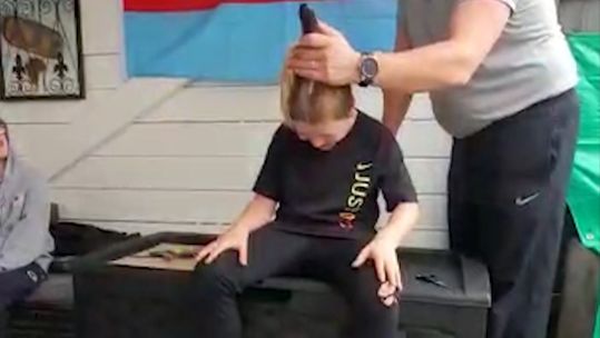 Jay Horner's dad Colour Sergeant Jack Horner helps him shave his head on his 10th birthday for Help For Heroes 080920 CREDIT FACEBOOK SUSAN HORNER