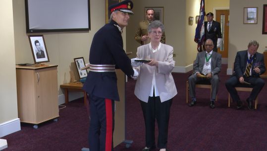 June Thompson receives Elizabeth Cross